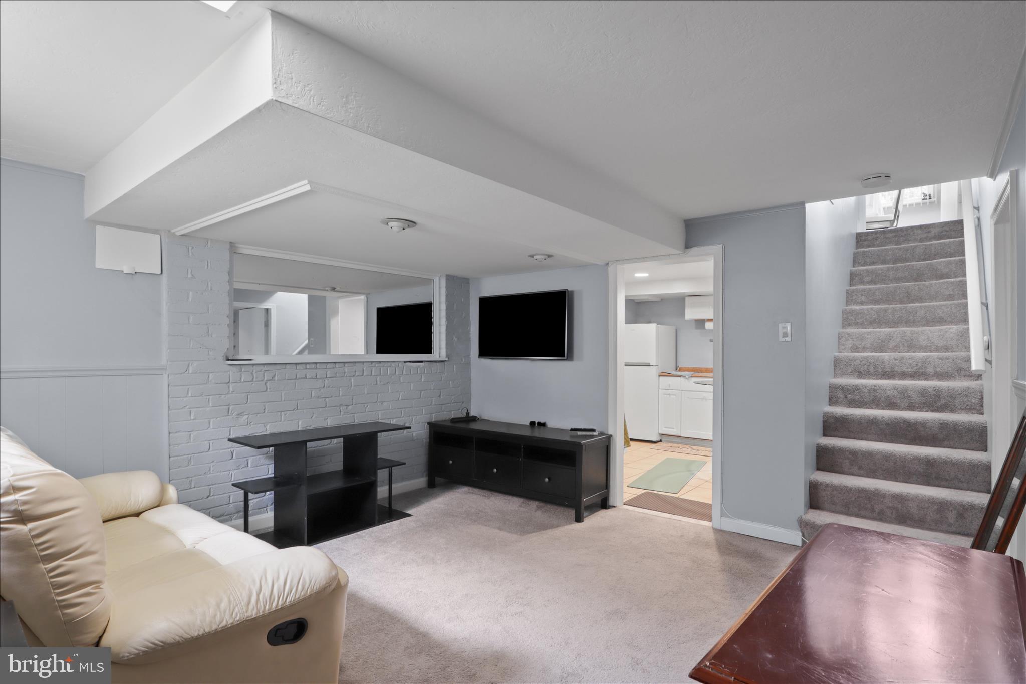 10602 Edgewood Avenue Silver Spring, MD 20901 - Photo 27 of 66 a living room with furniture and a flat screen tv