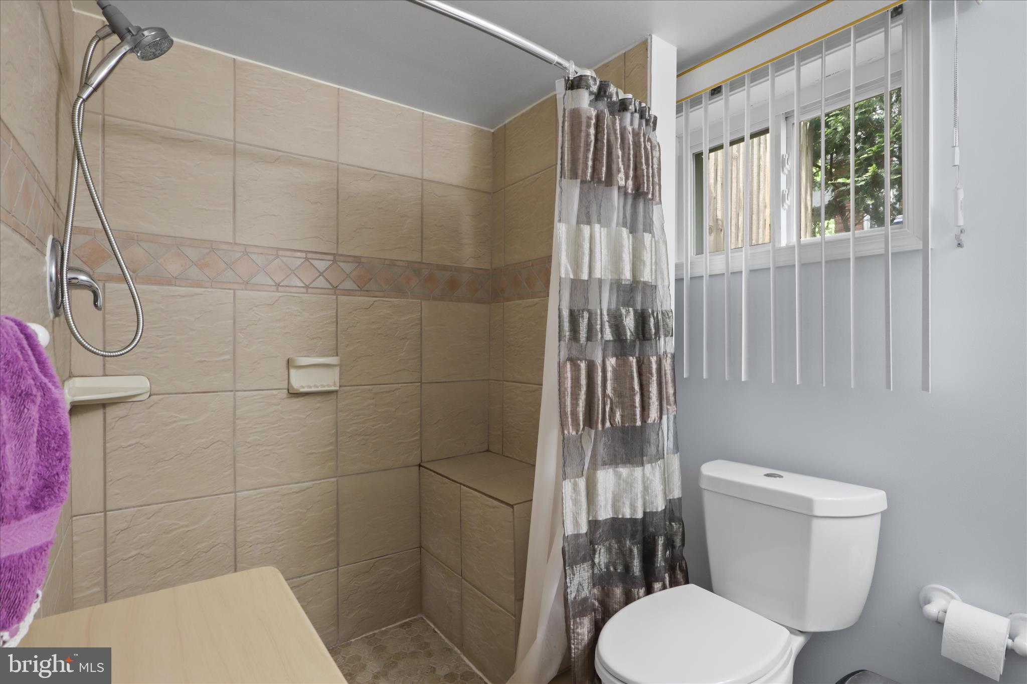 10602 Edgewood Avenue Silver Spring, MD 20901 - Photo 31 of 66 a white toilet sitting next to a bathroom sink