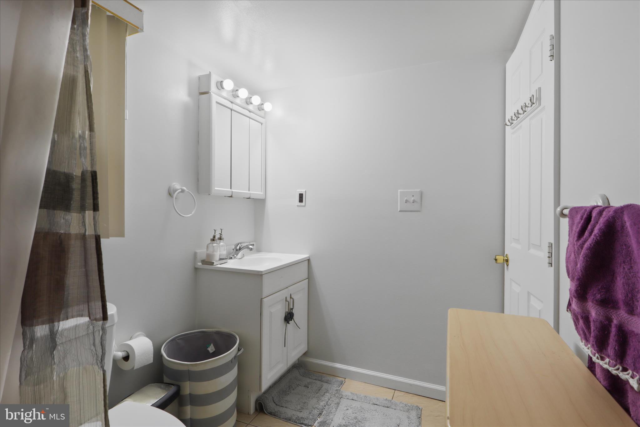 10602 Edgewood Avenue Silver Spring, MD 20901 - Photo 32 of 66 a bathroom with a sink toilet and mirror
