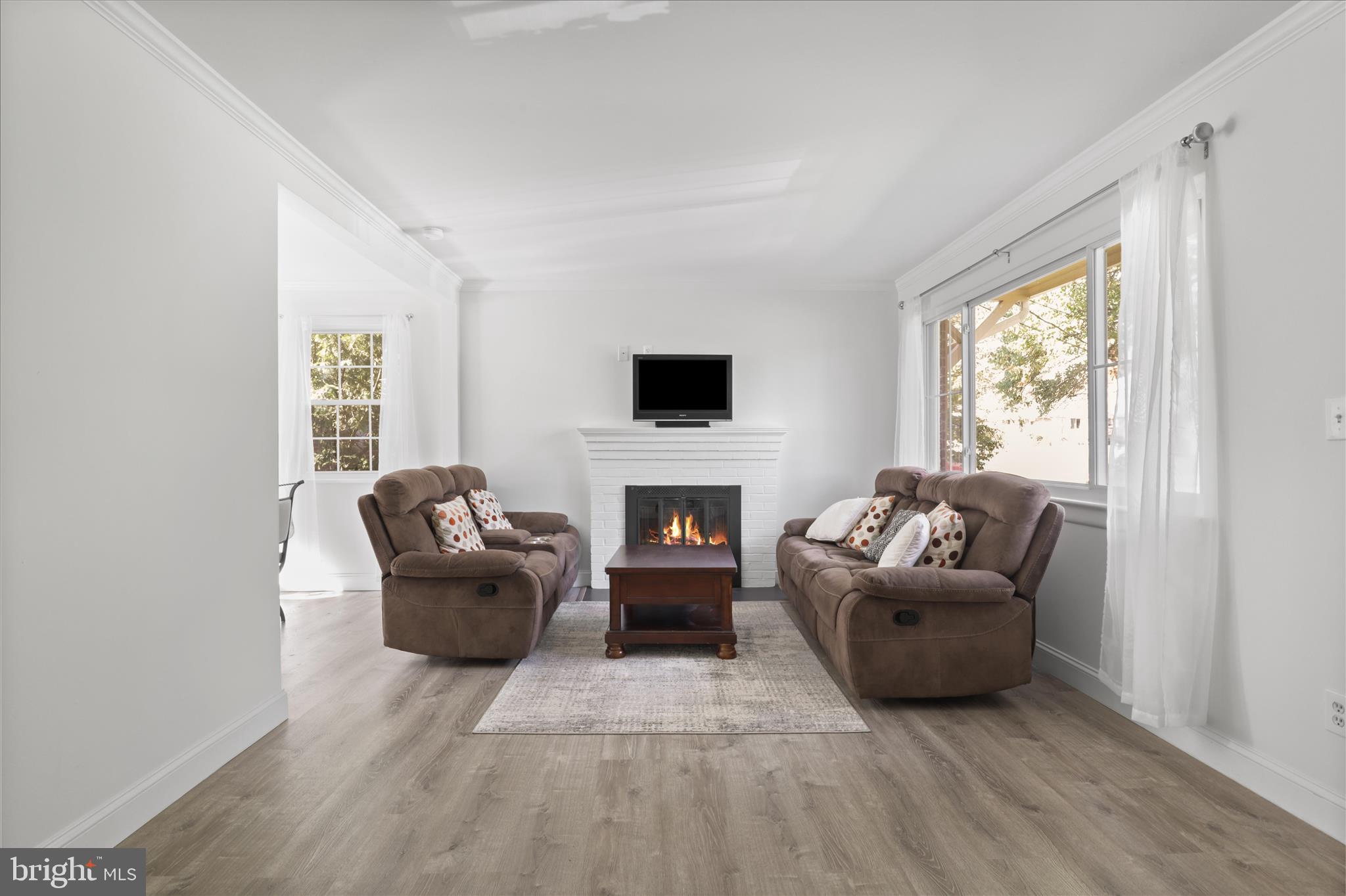 10602 Edgewood Avenue Silver Spring, MD 20901 - Photo 38 of 66 a living room with furniture a fireplace and a flat screen tv