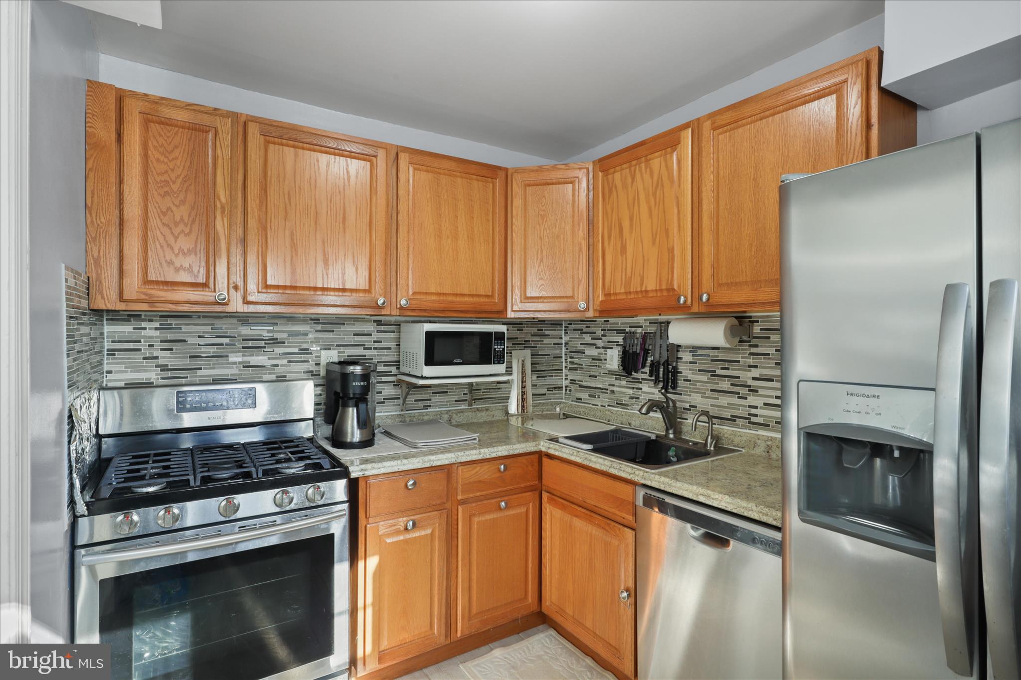 10602 Edgewood Avenue Silver Spring, MD 20901 - Photo 42 of 66 a kitchen with stainless steel appliances granite countertop a stove a refrigerator and a sink