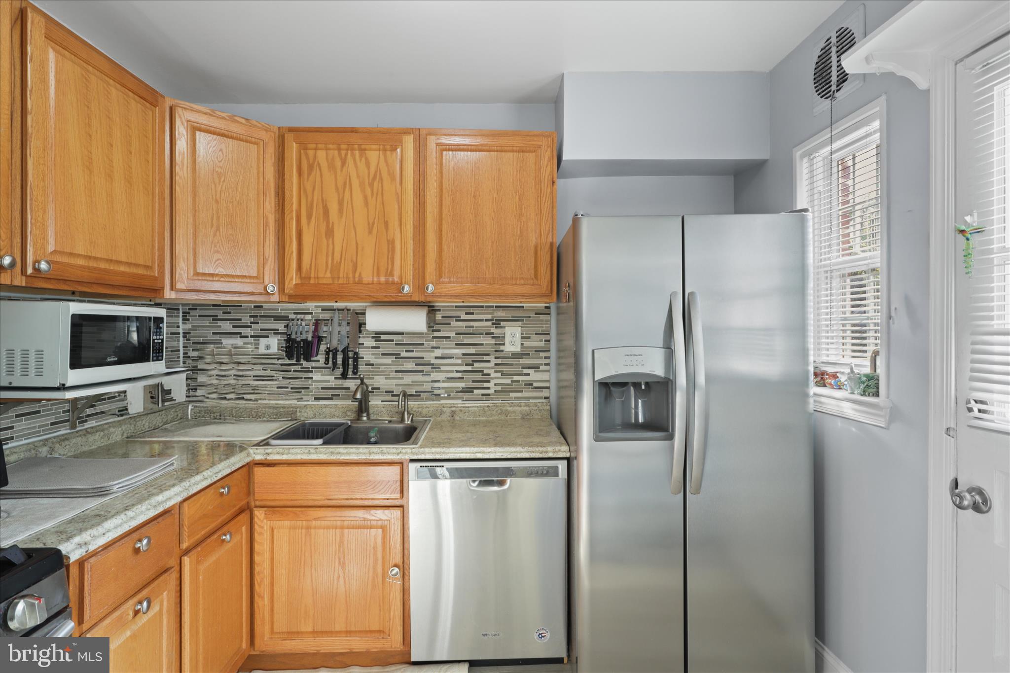 10602 Edgewood Avenue Silver Spring, MD 20901 - Photo 43 of 66 a kitchen with stainless steel appliances granite countertop a refrigerator and a sink