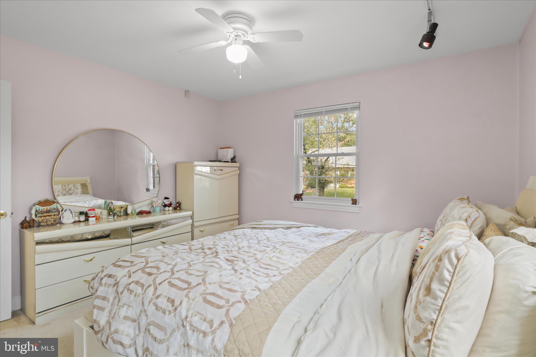 10602 Edgewood Avenue Silver Spring, MD 20901 - Photo 52 of 66 a bedroom with a bed and a chandelier