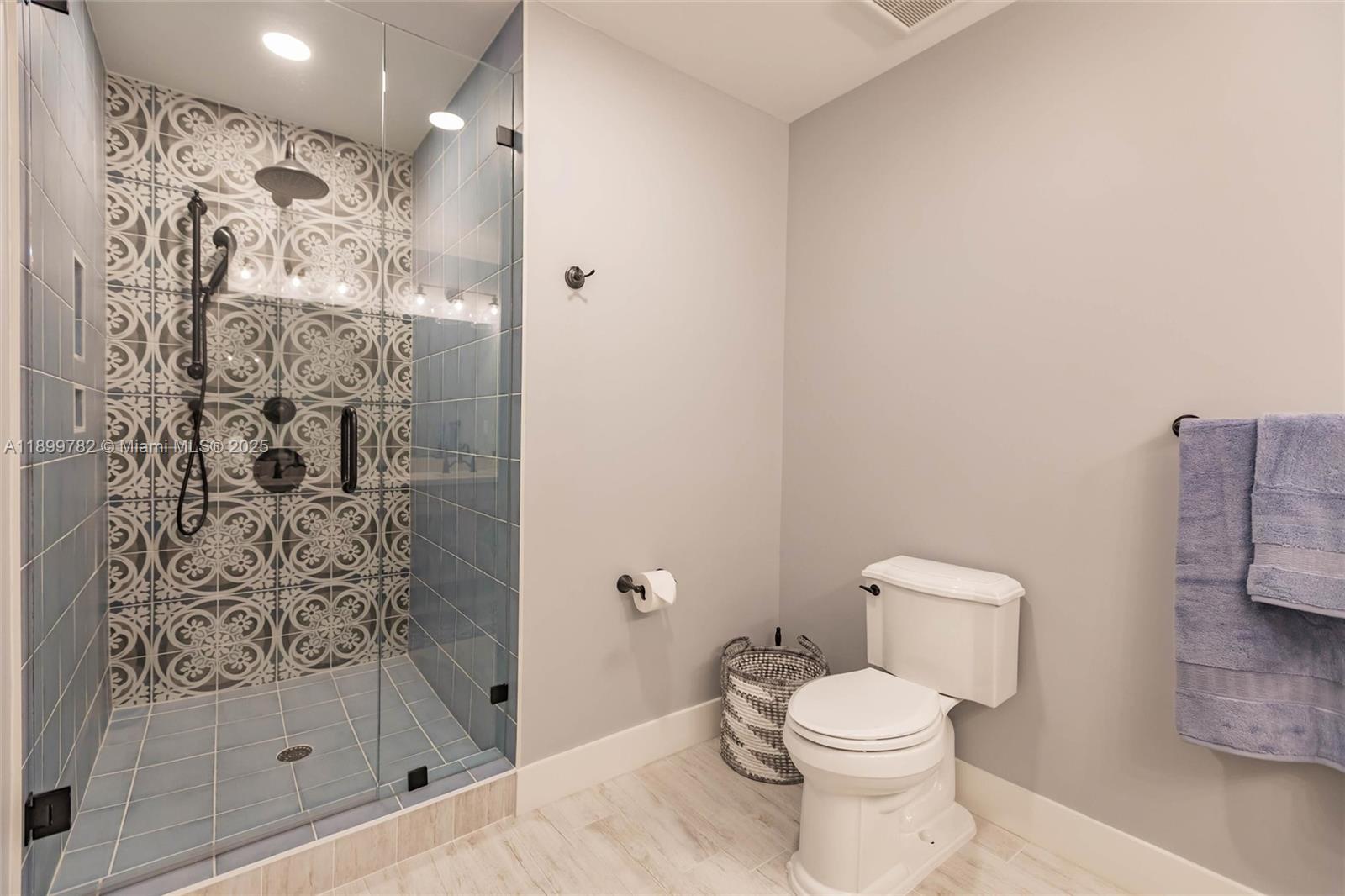 117 Ocean Key Way Jupiter, FL 33477 - Photo 13 of 57 a white toilet sitting next to a bathroom sink