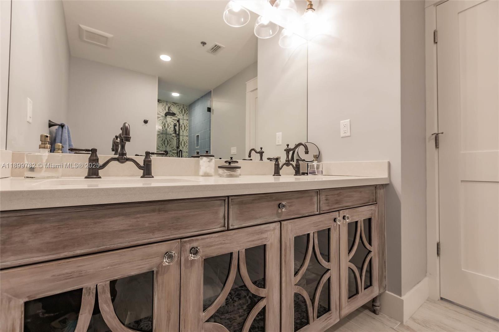 117 Ocean Key Way Jupiter, FL 33477 - Photo 14 of 57 a bathroom with a sink and a mirror