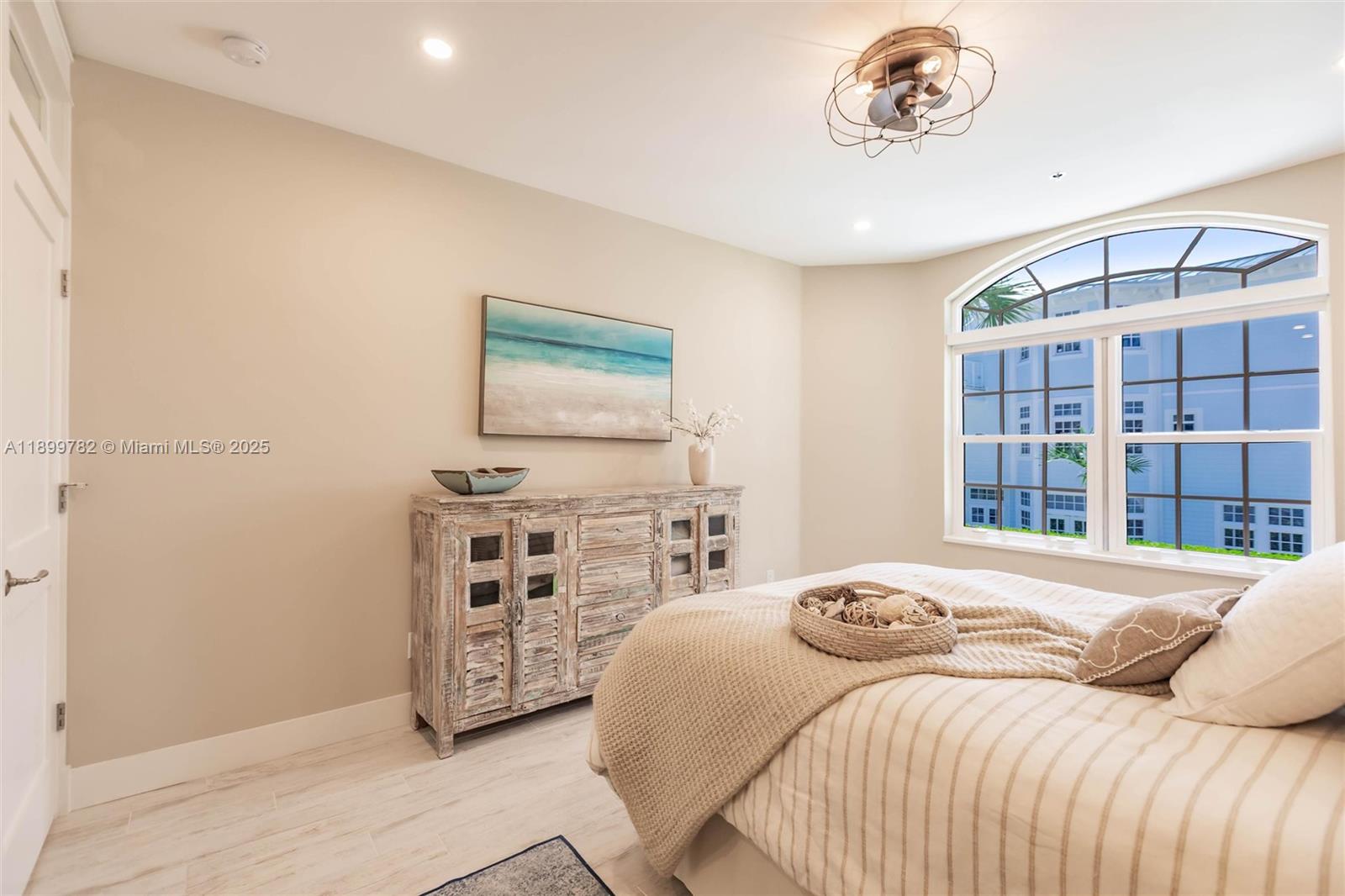 117 Ocean Key Way Jupiter, FL 33477 - Photo 20 of 57 a bedroom with a bed and a flat screen tv