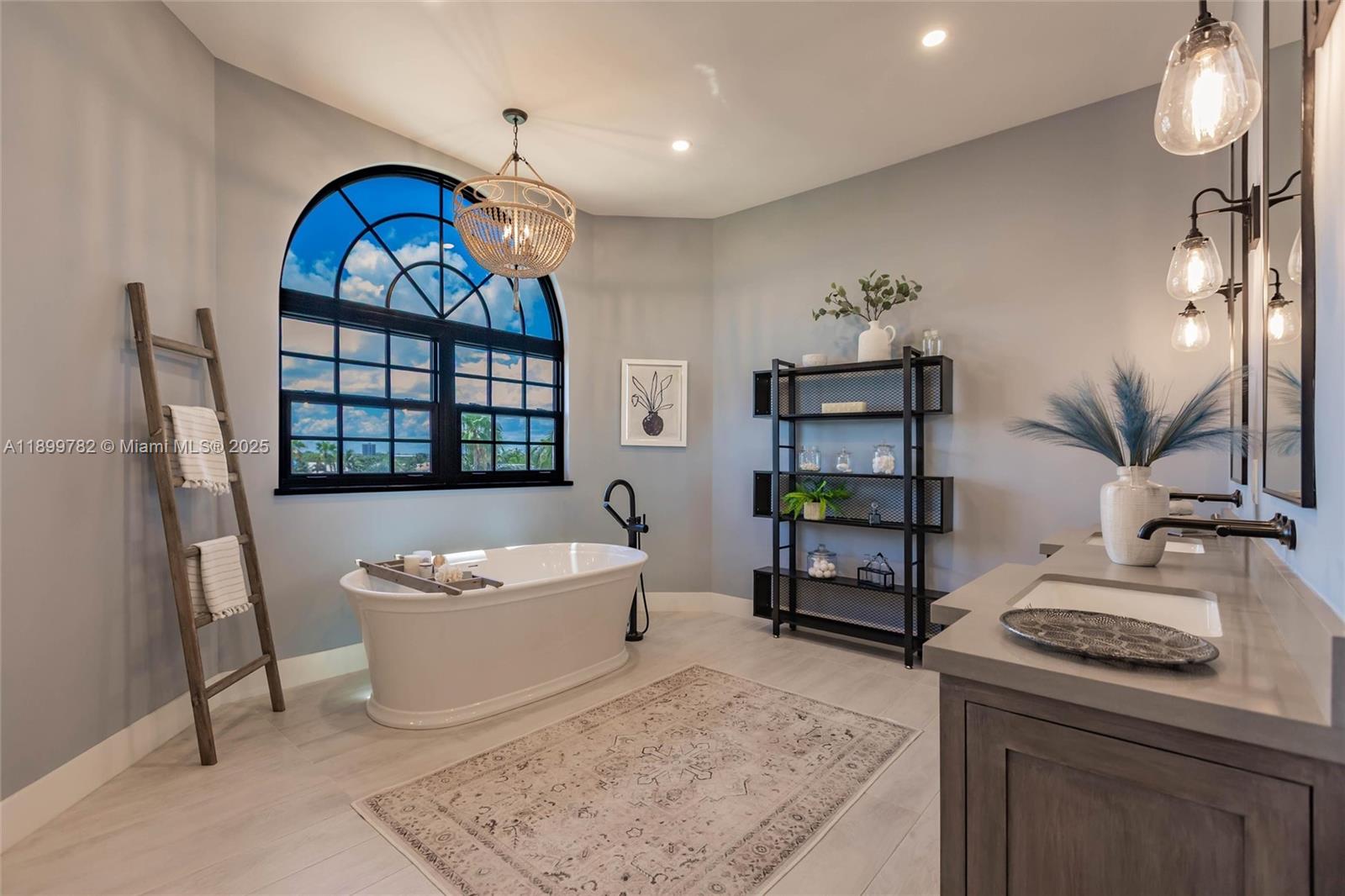 117 Ocean Key Way Jupiter, FL 33477 - Photo 42 of 57 a living room with a couch and a chandelier