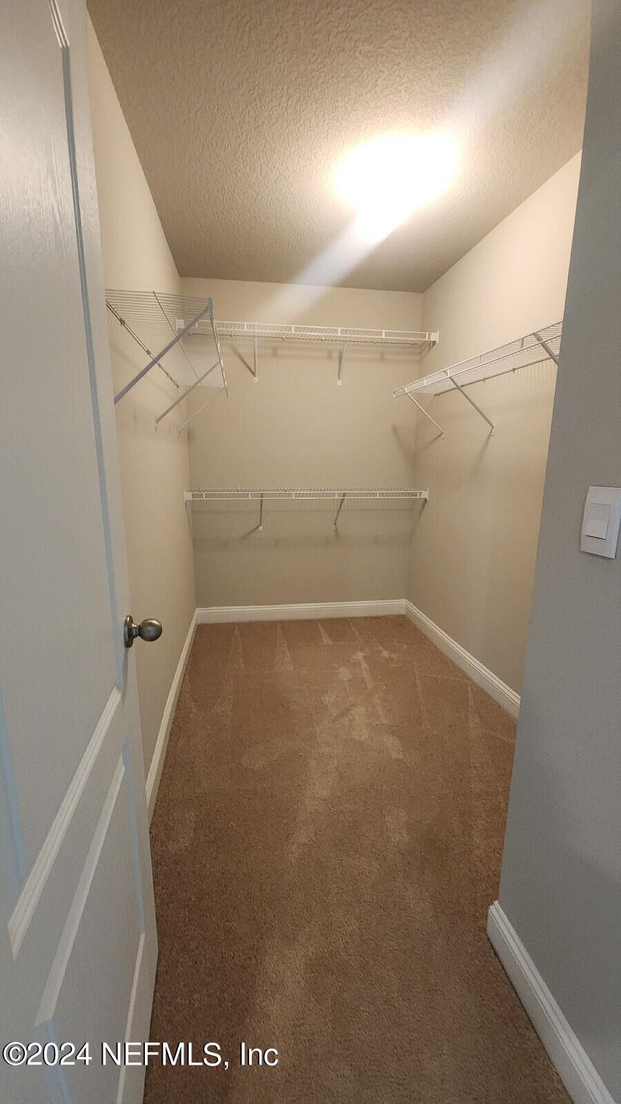 289 Narvarez Circle St. Augustine, FL 32084 - Photo 12 of 25 view of a room with racks on the wall
