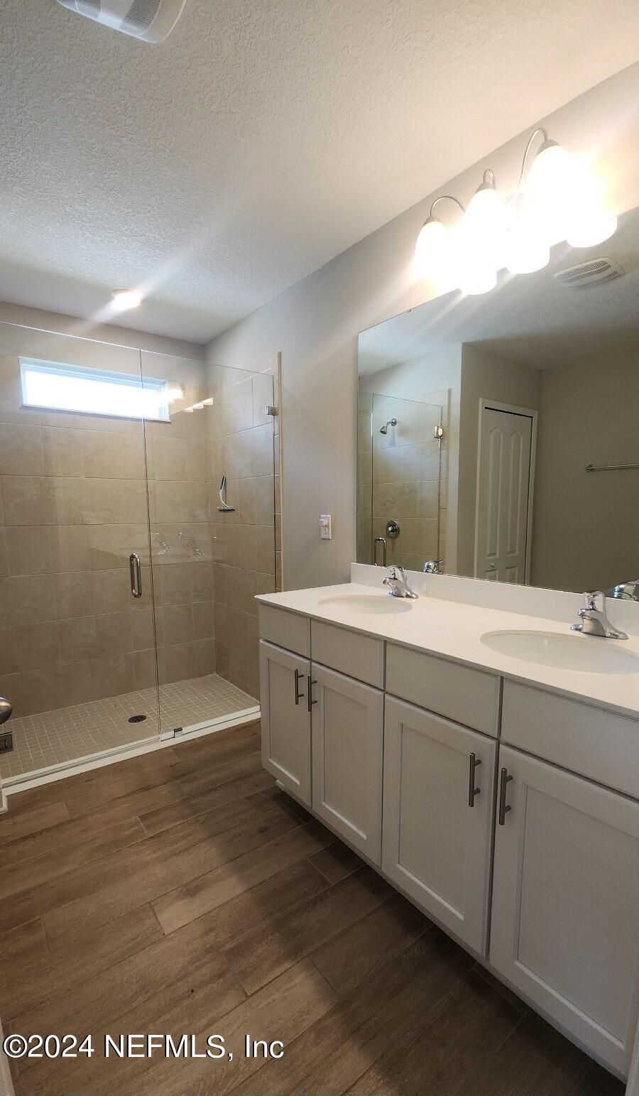 289 Narvarez Circle St. Augustine, FL 32084 - Photo 13 of 25 a spacious bathroom with a shower a sink and mirror