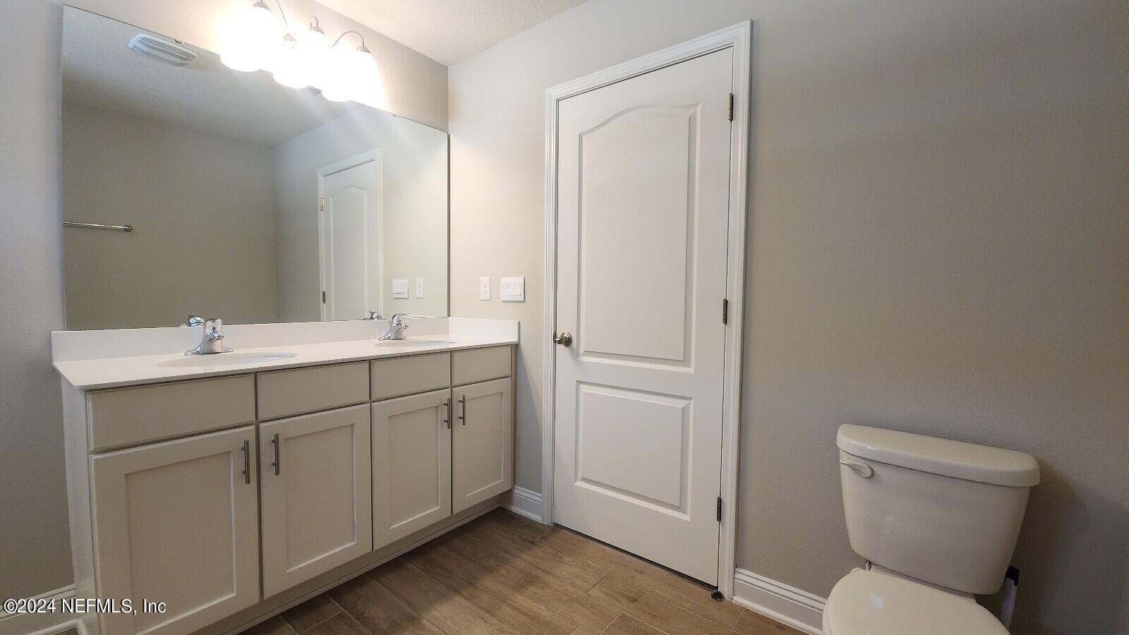 289 Narvarez Circle St. Augustine, FL 32084 - Photo 14 of 25 a bathroom with a toilet sink and mirror