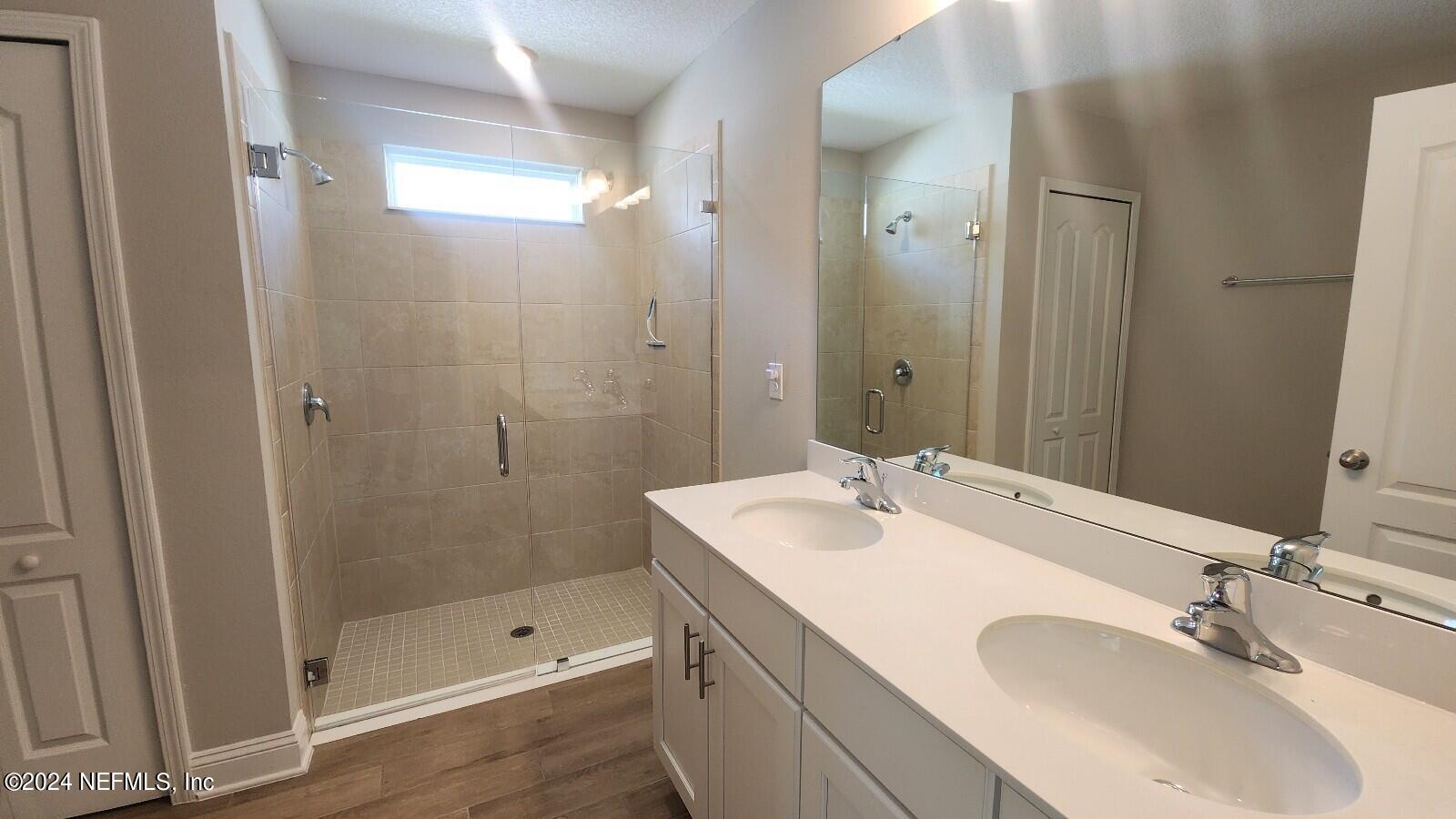 289 Narvarez Circle St. Augustine, FL 32084 - Photo 15 of 25 a bathroom with a sink double vanity and shower