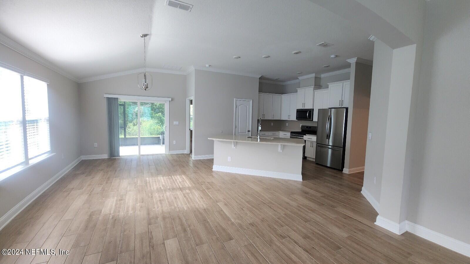 289 Narvarez Circle St. Augustine, FL 32084 - Photo 4 of 25 a view of kitchen with granite countertop stainless steel appliances cabinets and wooden floor