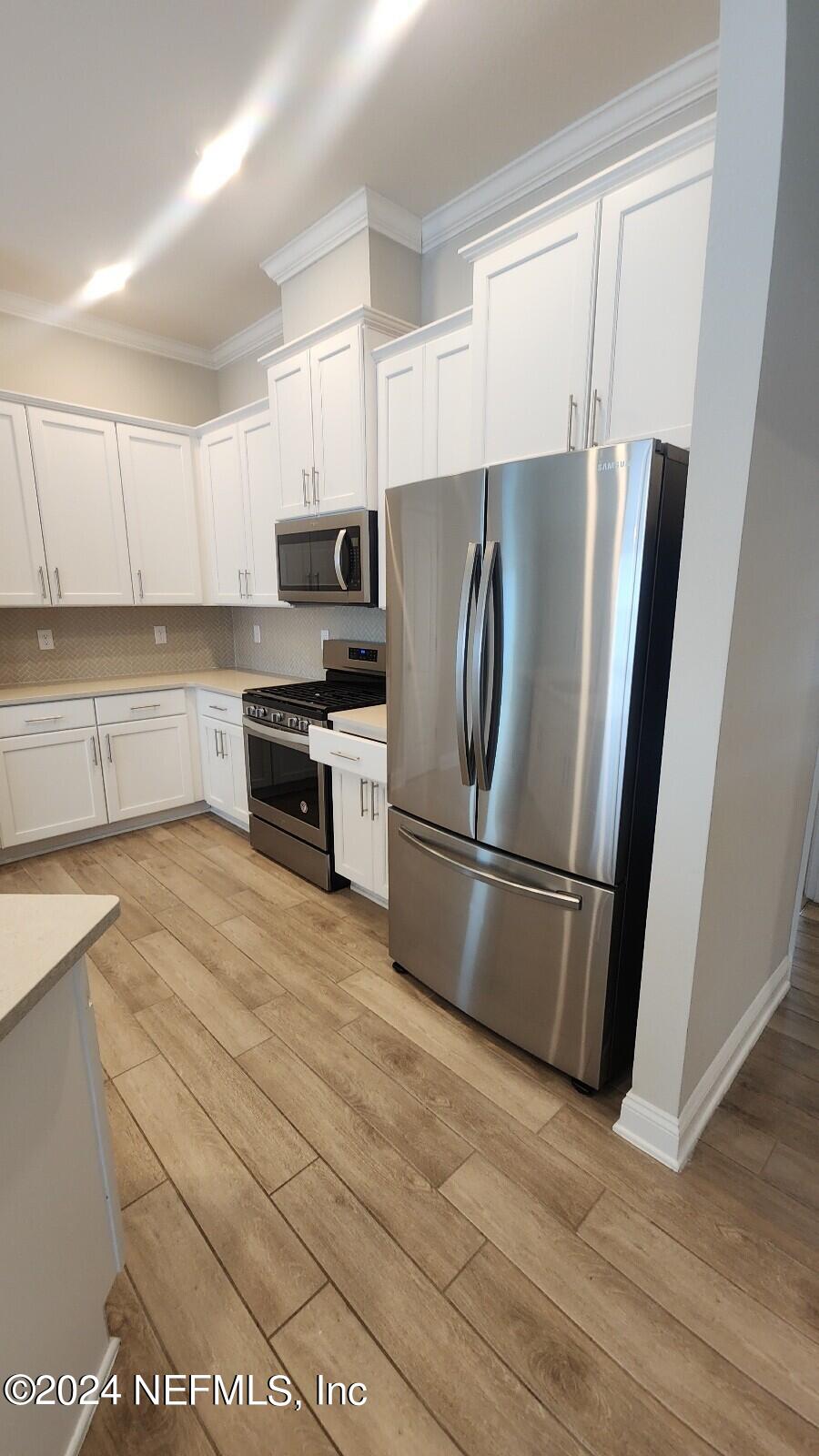 289 Narvarez Circle St. Augustine, FL 32084 - Photo 6 of 25 a kitchen with stainless steel appliances a refrigerator sink and microwave