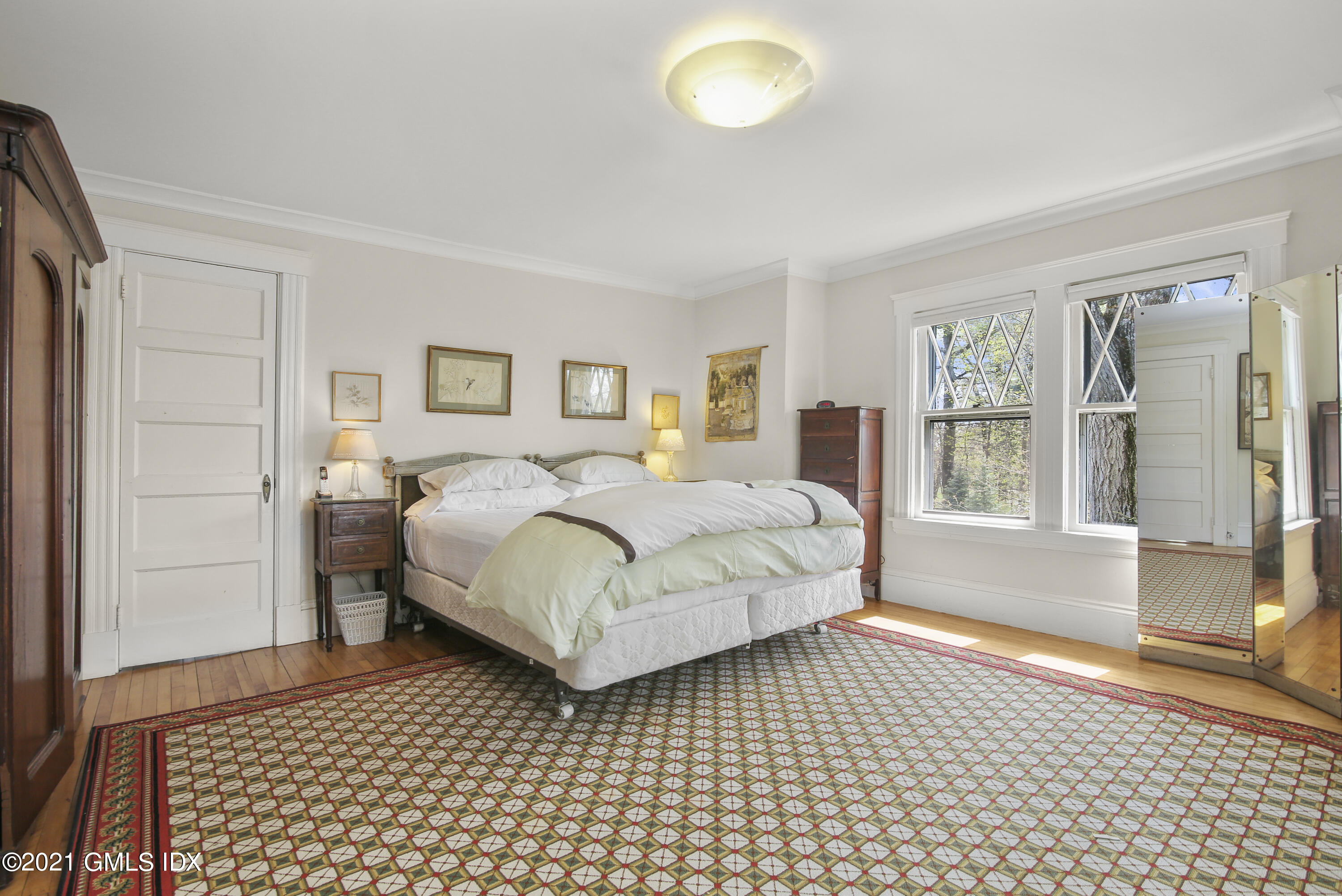 97 Hillcrest Park Road Old Greenwich, CT 06870 - Photo 14 of 25 a bedroom with a bed and a large window