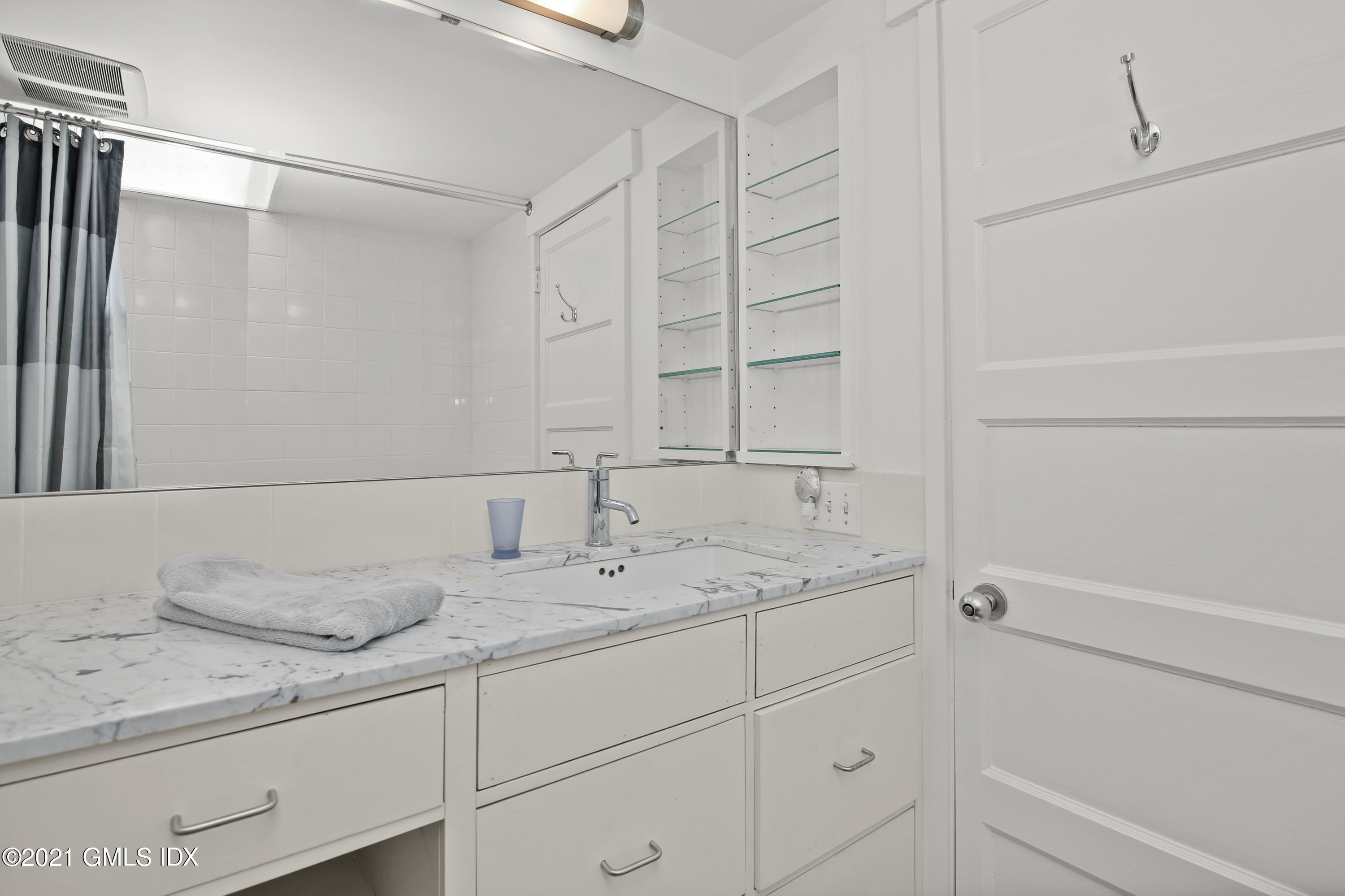97 Hillcrest Park Road Old Greenwich, CT 06870 - Photo 18 of 25 a bathroom with a sink and a mirror