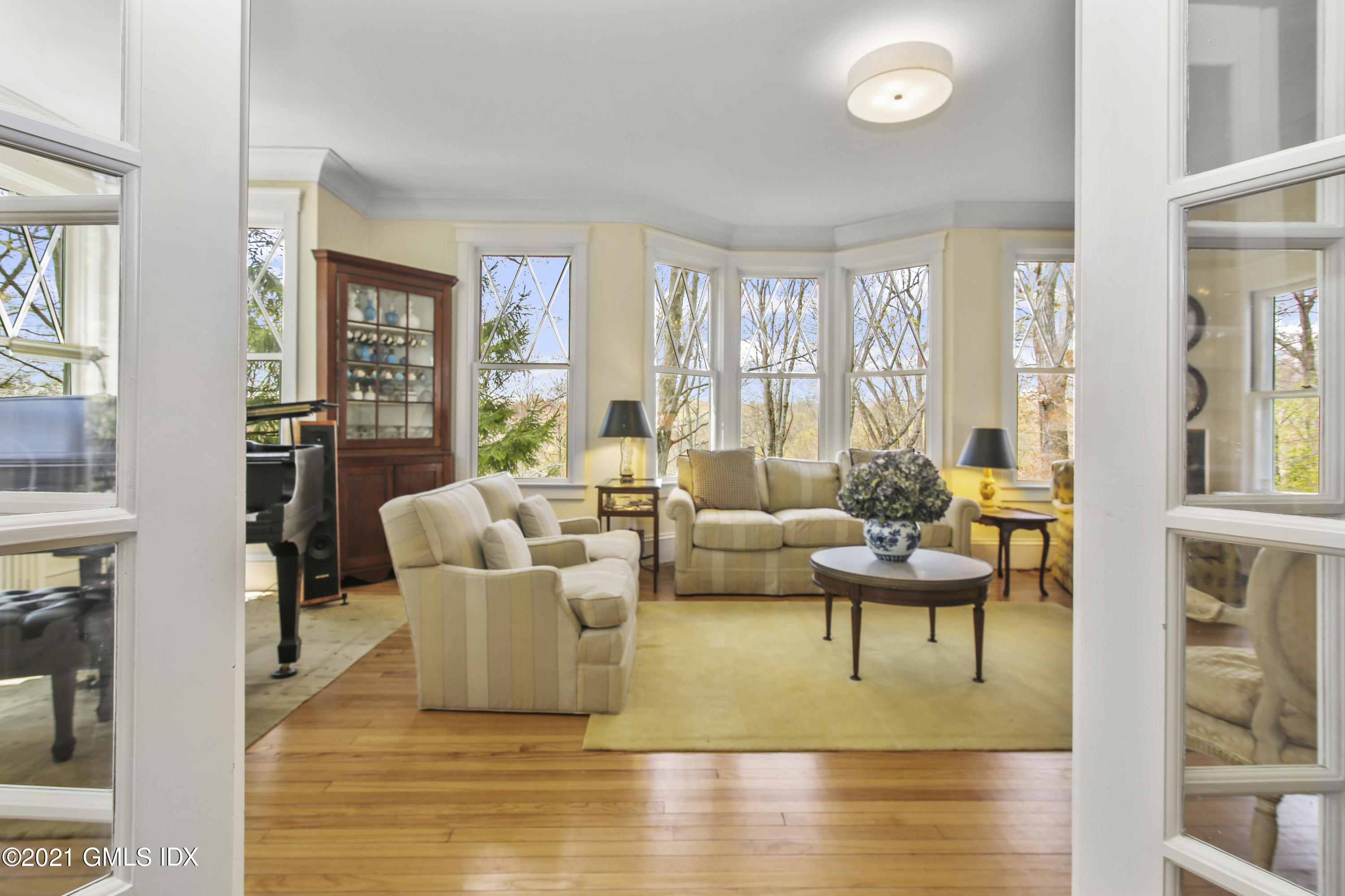 97 Hillcrest Park Road Old Greenwich, CT 06870 - Photo 7 of 25 a living room with fireplace furniture and a large window