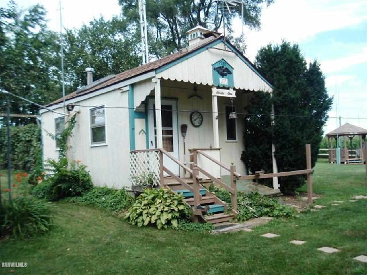 3360 South Rock City Road Ridott, IL 61067 - Photo 2 of 10 a front view of house with a garden