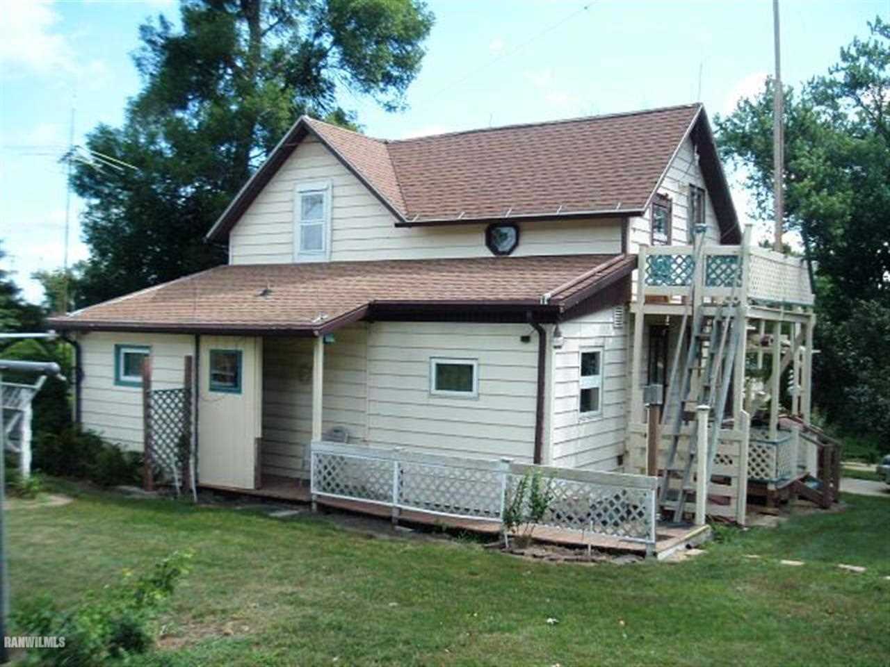3360 South Rock City Road Ridott, IL 61067 - Photo 3 of 10 a front view of a house with a garden