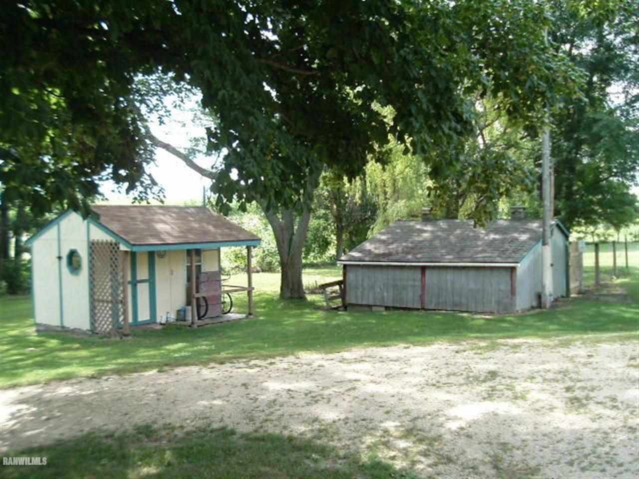 3360 South Rock City Road Ridott, IL 61067 - Photo 4 of 10 a view of a house with a yard and large tree