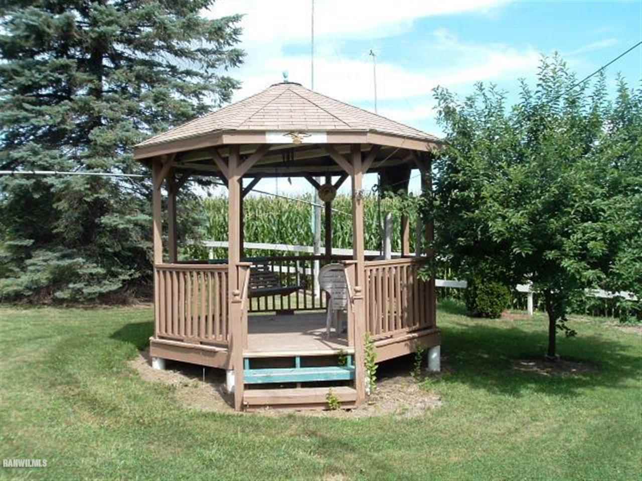 3360 South Rock City Road Ridott, IL 61067 - Photo 7 of 10 a view of a chair and table in the yard