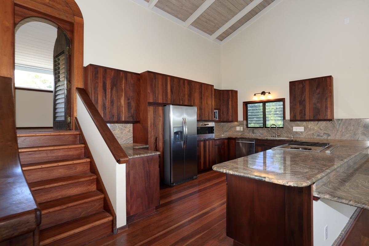 5045 Lower Honoapiilani Road, Unit 6 Lahaina, HI 96761 - Photo 12 of 30 a kitchen with granite countertop a sink dishwasher stove and refrigerator with wooden floor