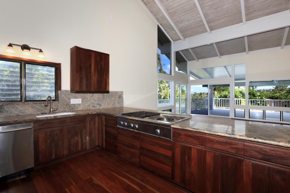5045 Lower Honoapiilani Road, Unit 6 Lahaina, HI 96761 - Photo 13 of 30 a kitchen with stainless steel appliances granite countertop a sink a stove a counter space and cabinets