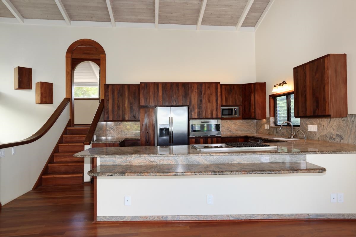 5045 Lower Honoapiilani Road, Unit 6 Lahaina, HI 96761 - Photo 15 of 30 a view of kitchen with stainless steel appliances granite countertop wooden floor and a sink