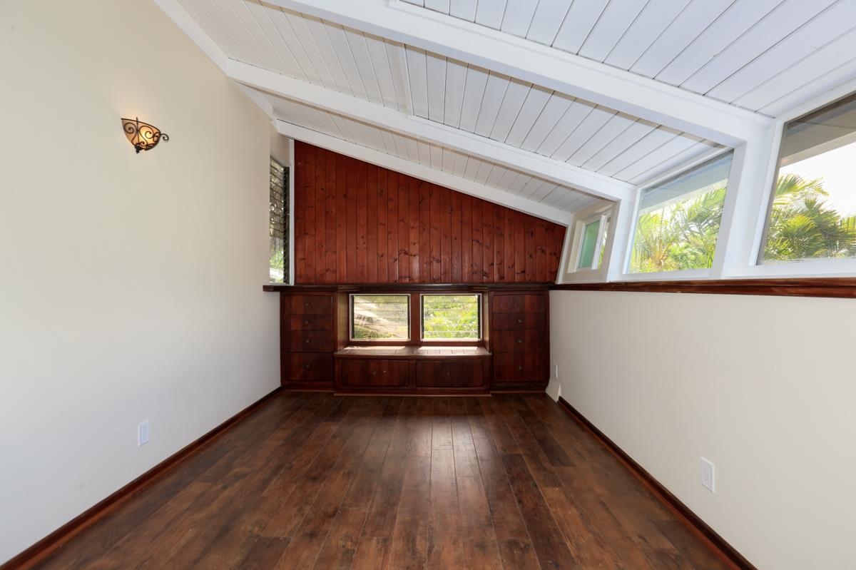 5045 Lower Honoapiilani Road, Unit 6 Lahaina, HI 96761 - Photo 16 of 30 an empty room with wooden floor and windows