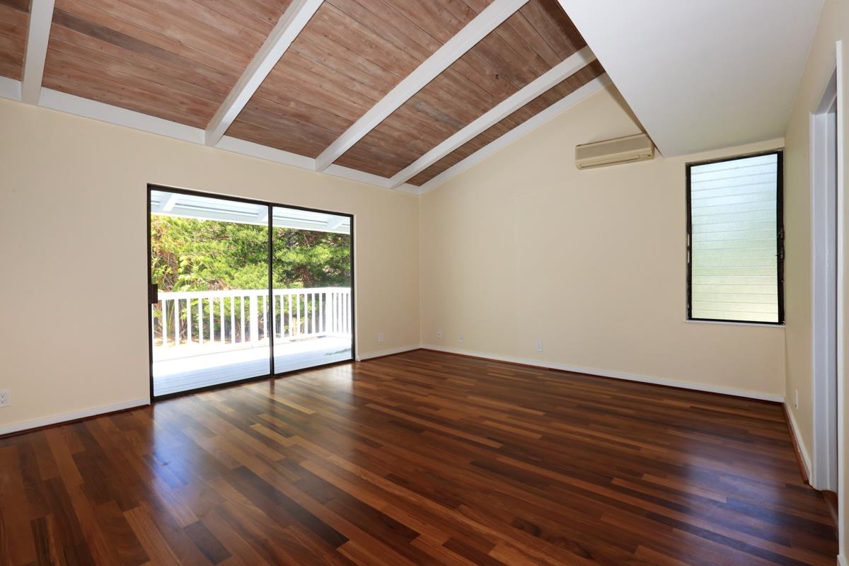 5045 Lower Honoapiilani Road, Unit 6 Lahaina, HI 96761 - Photo 21 of 30 a view of an empty room with wooden floor and a window