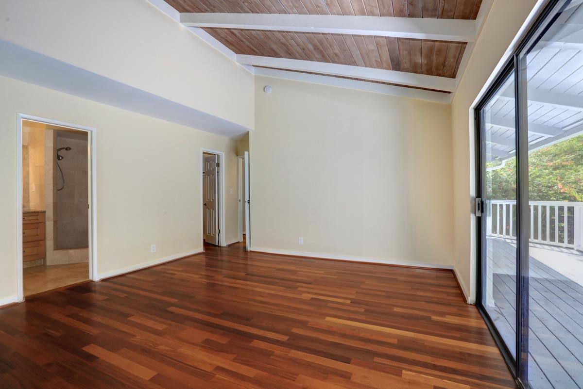 5045 Lower Honoapiilani Road, Unit 6 Lahaina, HI 96761 - Photo 22 of 30 a view of an empty room with wooden floor and a window