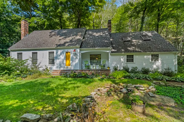 a view of a house with pool and garden
