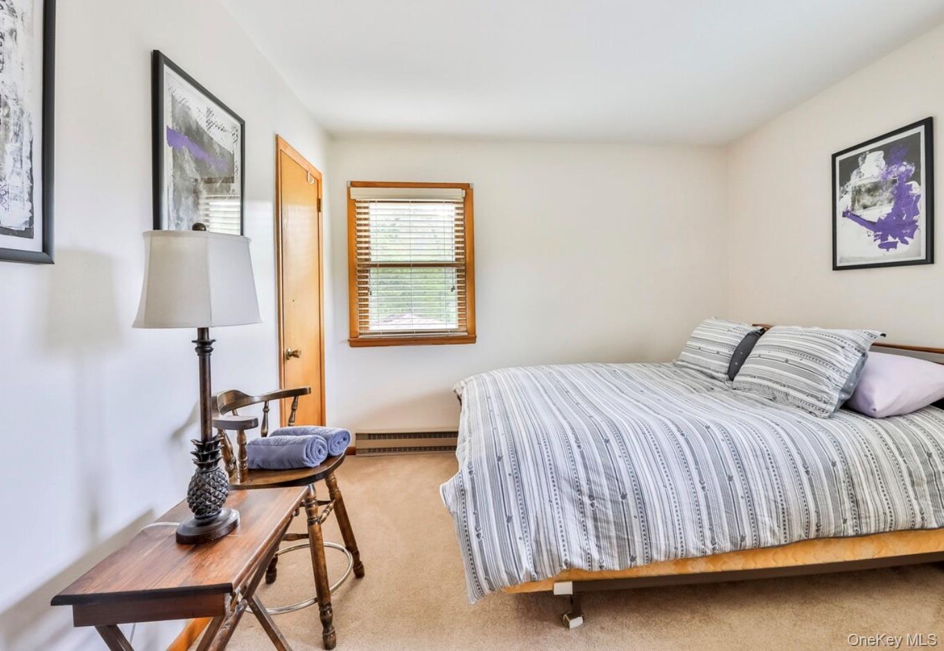 170 Maplecrest Road Windham, NY 12439 - Photo 24 of 36 a bedroom with a bed and a table in it