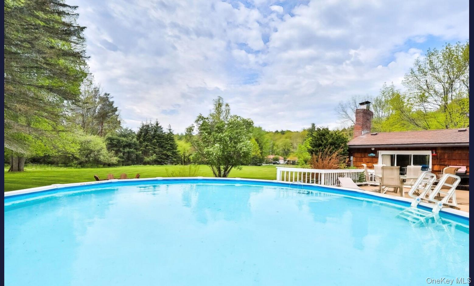 170 Maplecrest Road Windham, NY 12439 - Photo 3 of 36 a view of a swimming pool with an outdoor seating and a yard