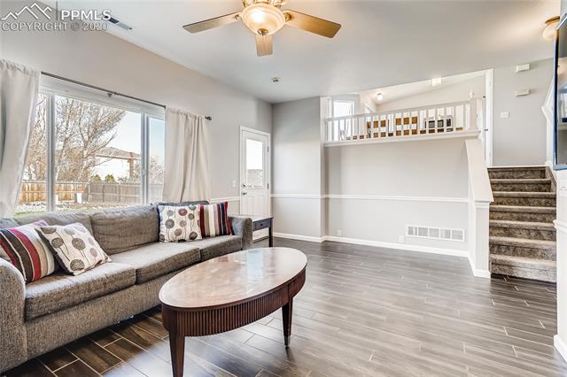 6652 Hannah Rose Road Colorado Springs, CO 80923 - Photo 12 of 28 Wood-Look Tile Flooring, and chair rail complements this great space.