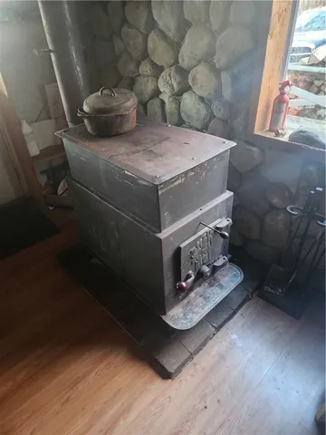 a room with water heater and wooden walls