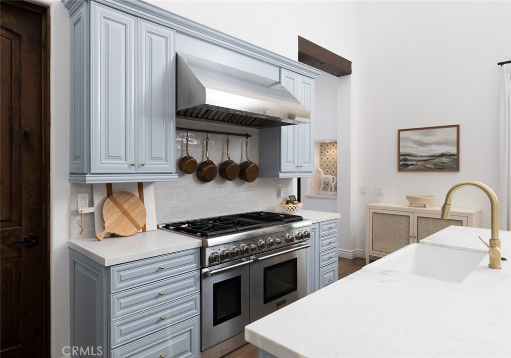 33240 La Serena Way Temecula, CA 92591 - Photo 18 of 75 a kitchen with stainless steel appliances a stove a sink and cabinets