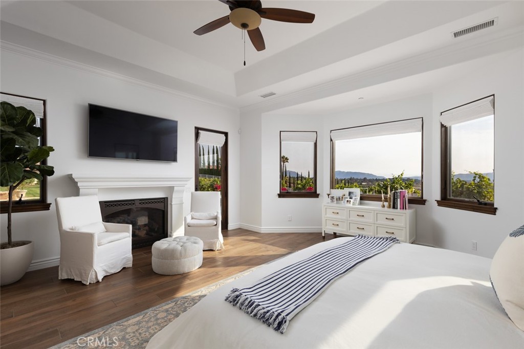 33240 La Serena Way Temecula, CA 92591 - Photo 21 of 75 a bedroom with a bed a flat screen tv and a fireplace