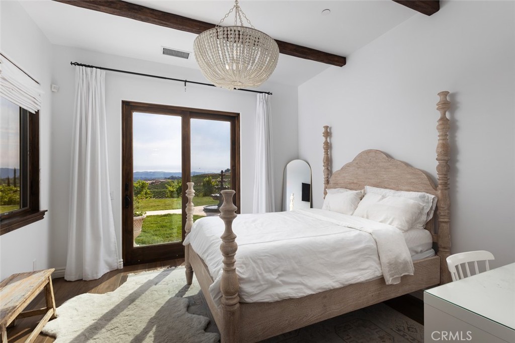 33240 La Serena Way Temecula, CA 92591 - Photo 27 of 75 a bedroom with a bed and a chandelier