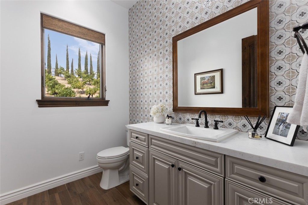33240 La Serena Way Temecula, CA 92591 - Photo 30 of 75 a bathroom with a toilet sink and mirror