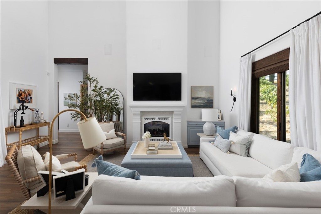 33240 La Serena Way Temecula, CA 92591 - Photo 10 of 75 a living room with furniture a fireplace and a flat screen tv