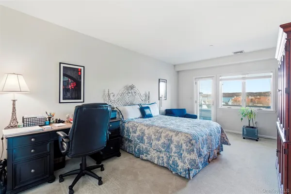 a bedroom with a bed a desk and chair