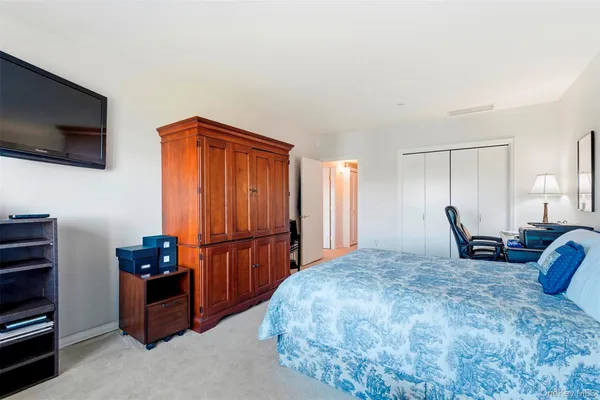 a bedroom with furniture and a flat screen tv