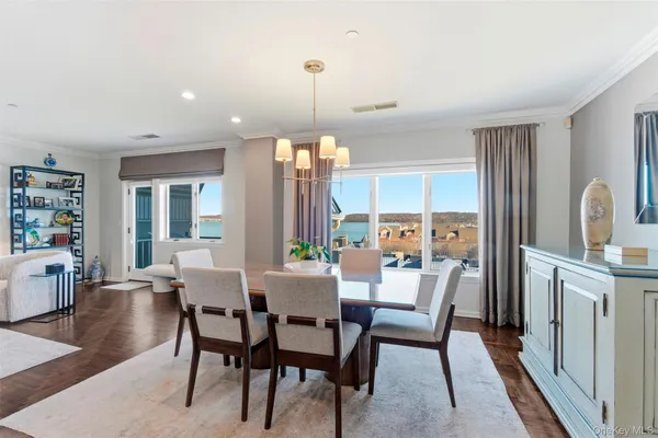 a view of a dining room with furniture window and wooden floor