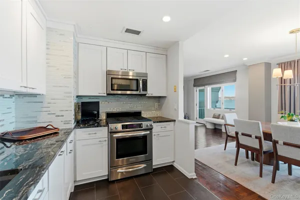 a kitchen with a stove a sink and a microwave