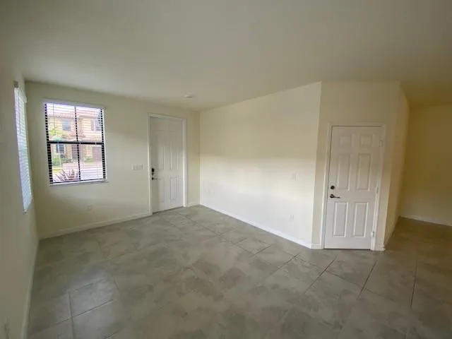 an empty room with windows and closet