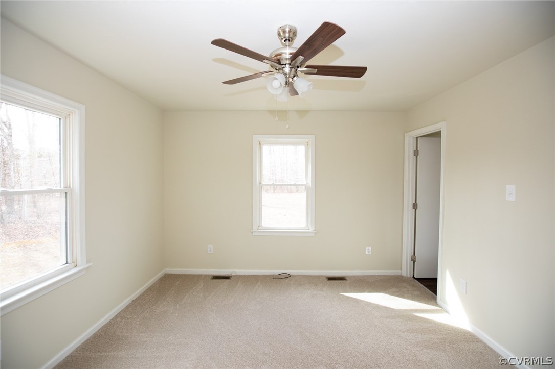37 Criss Road Cumberland, VA 23040 - Photo 17 of 40 an empty room with a window and a ceiling fan