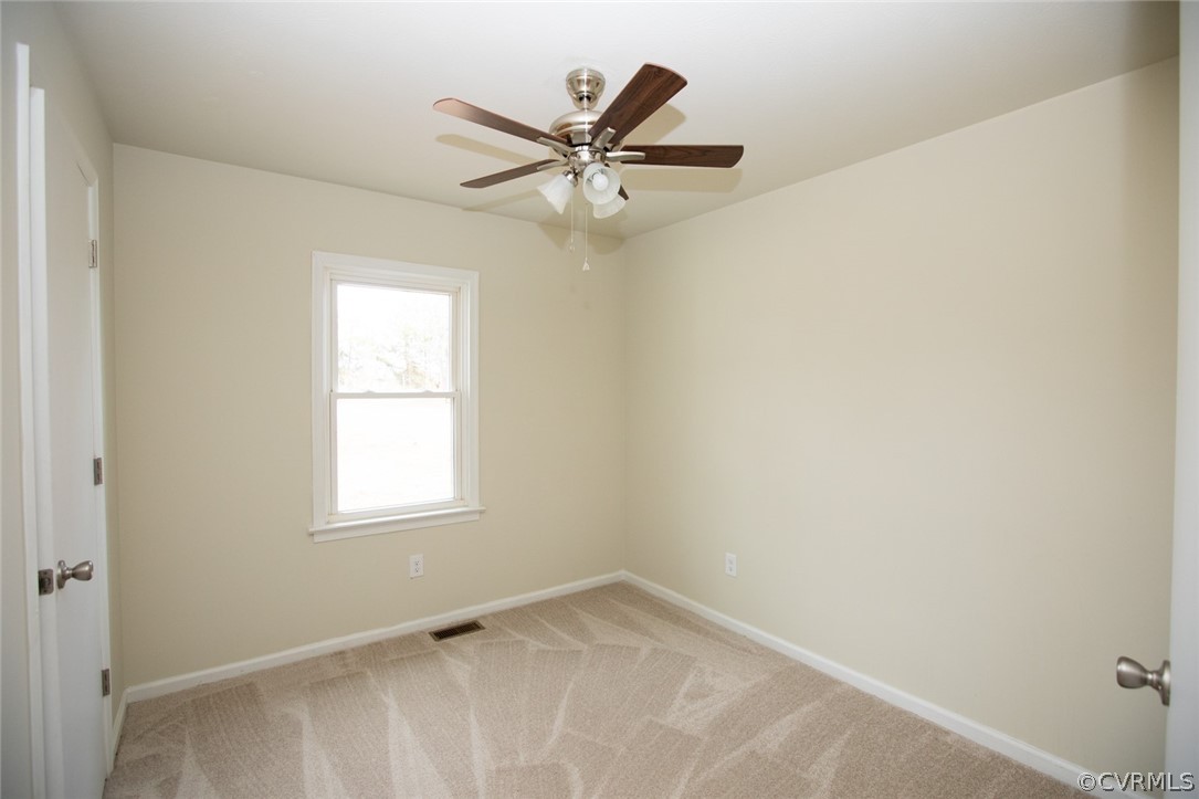 37 Criss Road Cumberland, VA 23040 - Photo 25 of 40 an empty room with a window and a ceiling fan