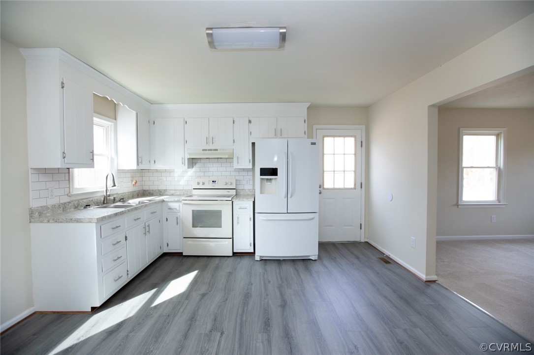 37 Criss Road Cumberland, VA 23040 - Photo 10 of 40 a kitchen with granite countertop white cabinets a sink dishwasher and a stove with wooden floor