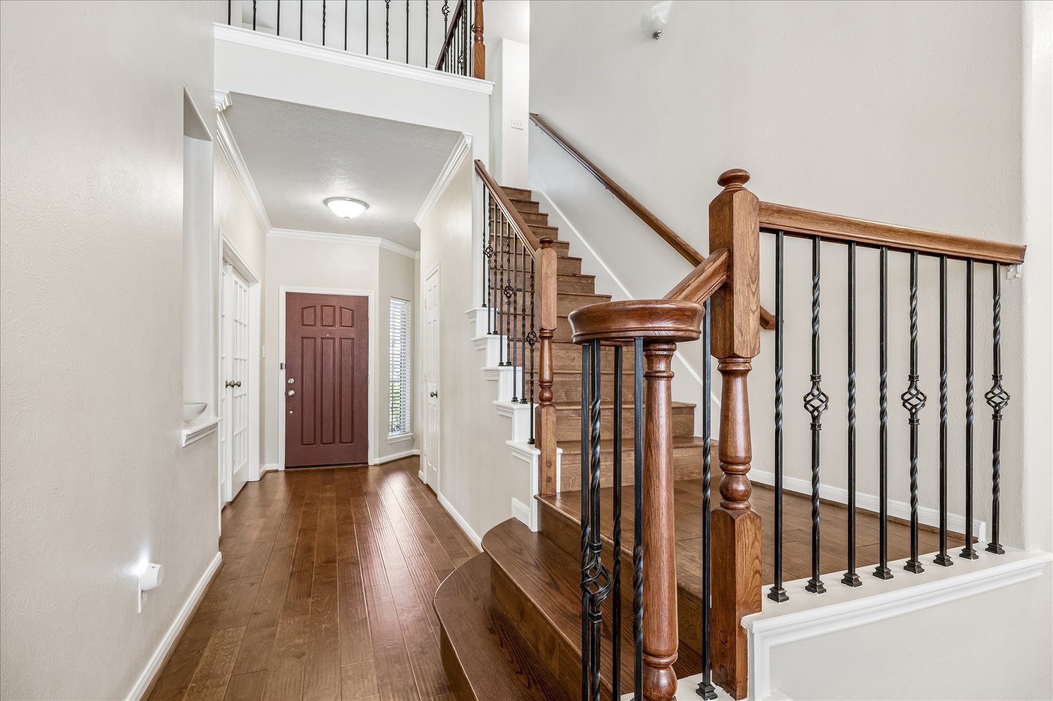 5811 Walkabout Way Katy, TX 77450 - Photo 12 of 33 Grand entry foyer showcasing rich wood flooring and elegant staircase detailing.