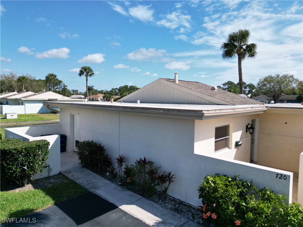 720 Joel Boulevard Lehigh Acres, FL 33936 - Photo 4 of 9 a front view of a house with a yard and potted plants